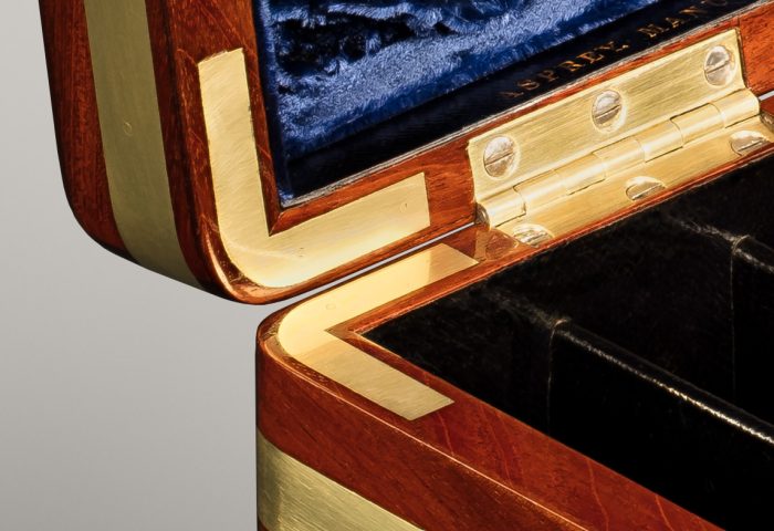 Brass corner mounts from an antique jewellery box in solid mahogany, by Asprey.