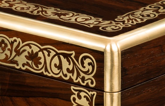 Radial brass edging on an antique jewellery box in rosewood with foliate brass inlay, by Austin of Dublin.