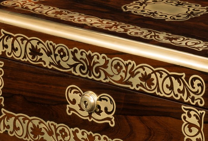 Inlaid foliate brass designs on an antique jewellery box in rosewood by Austin of Dublin.