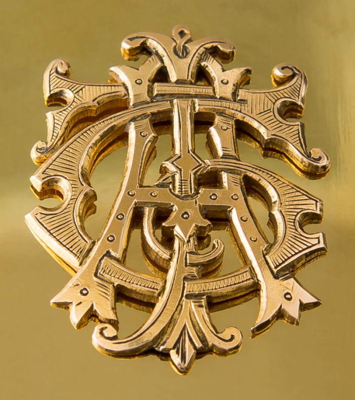 Mounted solid gold monogram from an antique silver-gilt dressing case fitting.