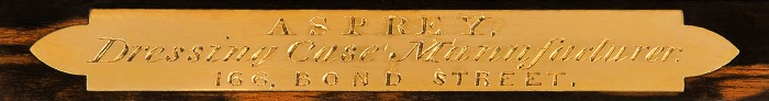 'Asprey - Dressing Case Manufacturer - 166. Bond Street' gilt-brass manufacturer's plate from an antique jewellery box in coromandel with brass inlay and secret compartments.