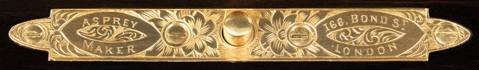 An Asprey engraved brass manufacturer's plate from an antique jewellery box in calamander.