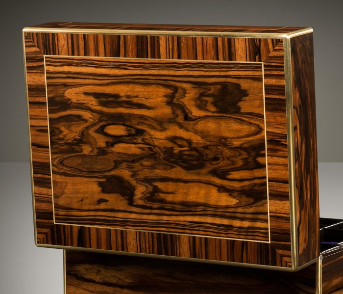 Cross-banded calamander veneer on an antique jewellery box with removable secret compartments, by Asprey.