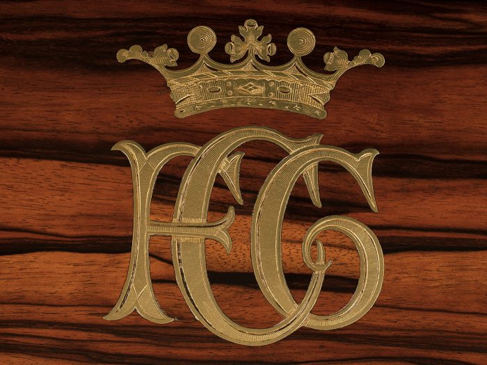 An engraved ‘F.G.C’ monogram beneath a marchioness’ coronet from an antique jewellery box in calamander by Asprey.