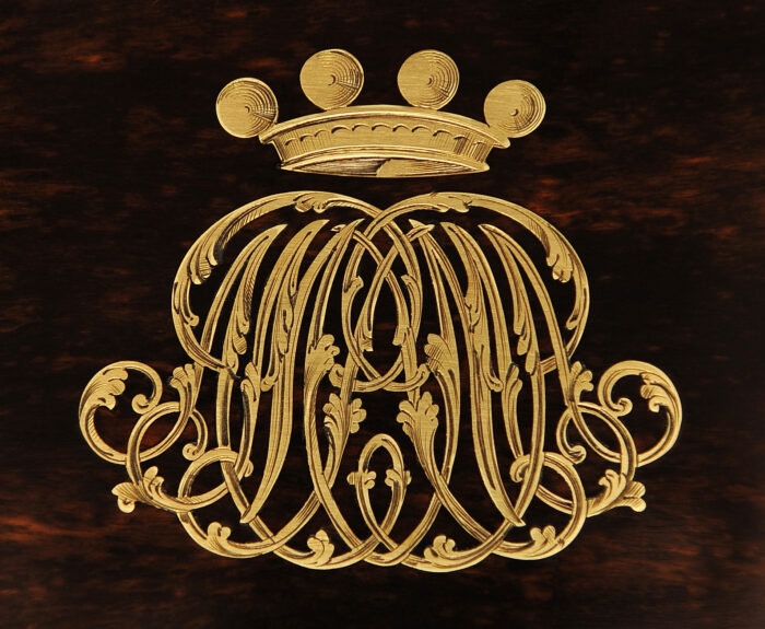 An engraved symmetrical ‘A.M.P’ monogram beneath a baroness’ coronet from an antique jewellery box in coromandel, by Leuchars.