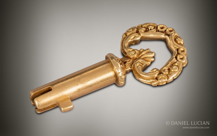 Bramah master key in 15k gold with decorative bow.