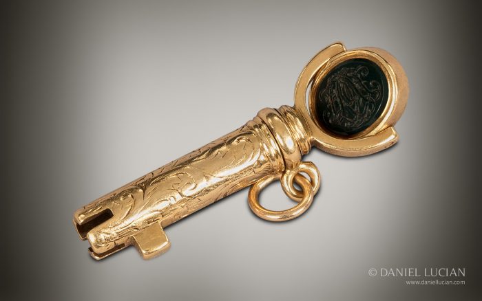 Bramah master key in 15k gold with revolving monogramed intaglio.