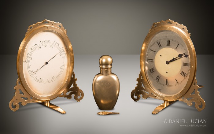 Strut barometer, strut clock and silver-gilt perfume bottle taken from an Asprey antique jewellery box in coromandel with Betjemann Patent mechanism and candlesticks.