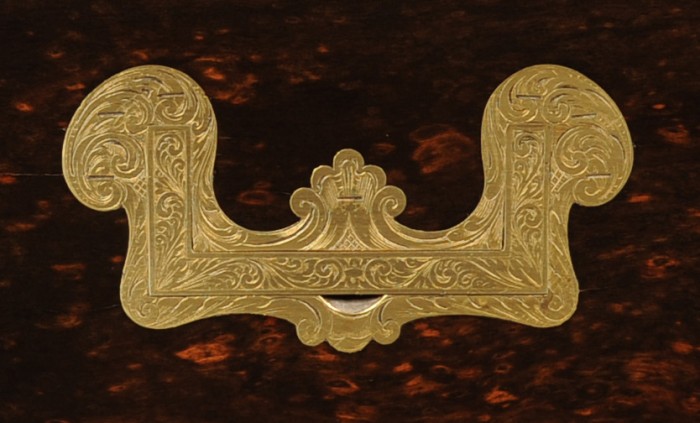 Sculpted brass handle with engraved decoration from an antique jewellery box in coromandel by Leuchars.