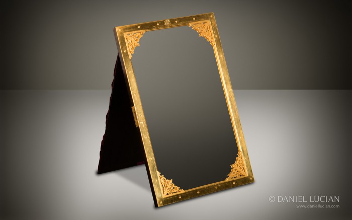 Gilt-brass mirror frame with fretworked brass corner mounts taken from an antique jewellery box in burr walnut.