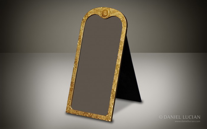 Gilt-brass mirror frame with engraved decoration taken from an antique dressing case by Jenner & Knewstub.