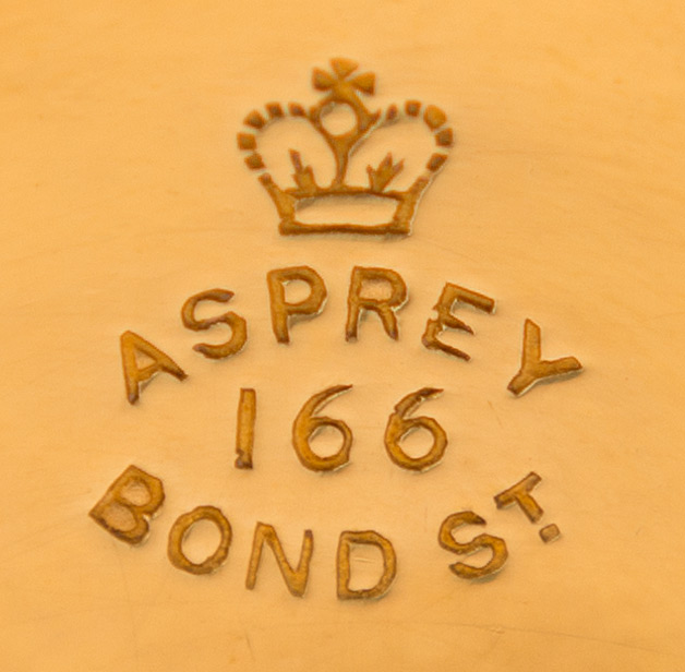 'Asprey - 166 Bond St' stamped into a silver-gilt dressing case fitting.