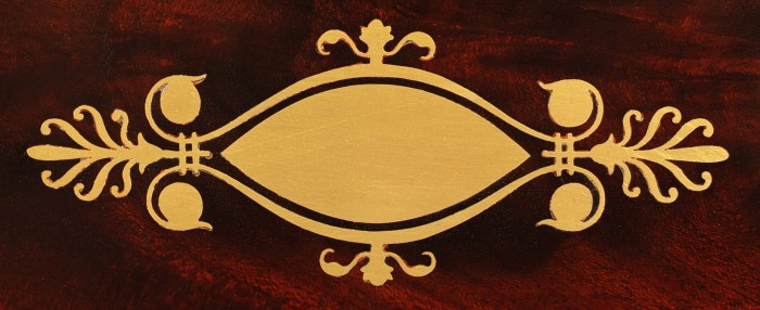 Decorative brass escutcheon from a French mahogany jewellery box.