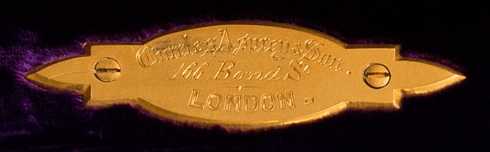 Charles Asprey & Son gilt-brass manufacturer's plate from an antique jewellery box in coromandel with Betjemann Patent mechanism & candlesticks.