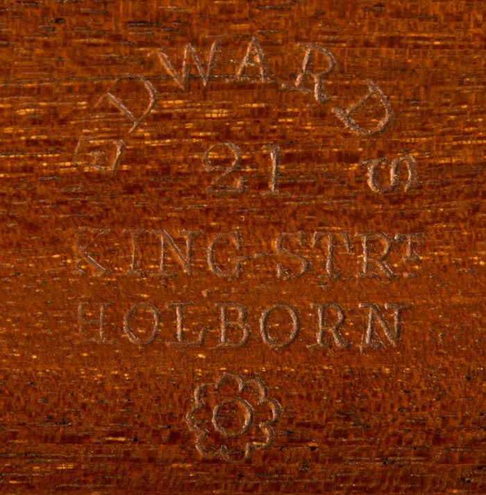 The manufacturer's and retailer's mark of, 'Edwards - 21 King Strt - Holborn' has been stamped into the wood.