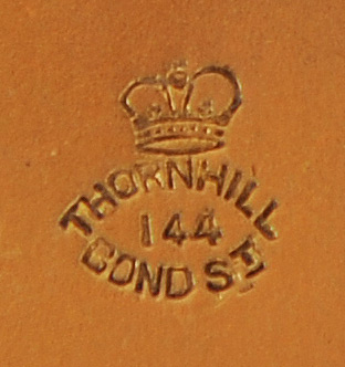 Thornhill manufacturer/ retailer stamp on the underside of a silver-gilt vanity jar lid.