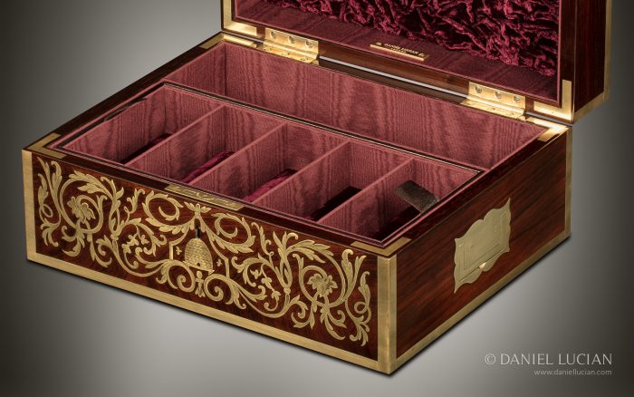 A Tompson Patent lock fitted into an antique jewellery box in rosewood with engraved brass inlay.
