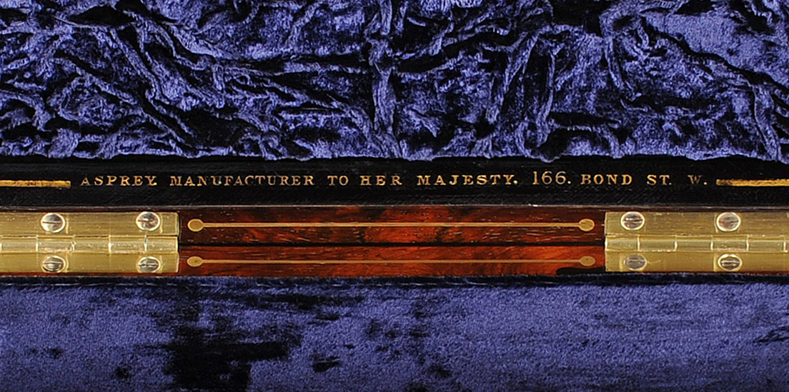 'Asprey. Manufacturer to Her Majesty. 166 Bond St. W.' manufacturer's mark gold tooled into leather.